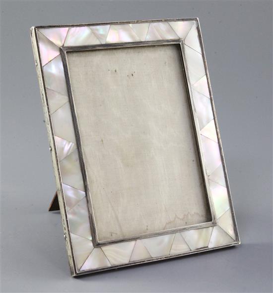 A 1920s silver and mother of pearl mounted photograph frame by Padgett & Braham, 18.4cm.